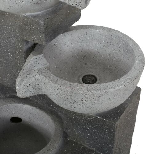 Contemporary concrete water fountain with smooth rounded basin design.