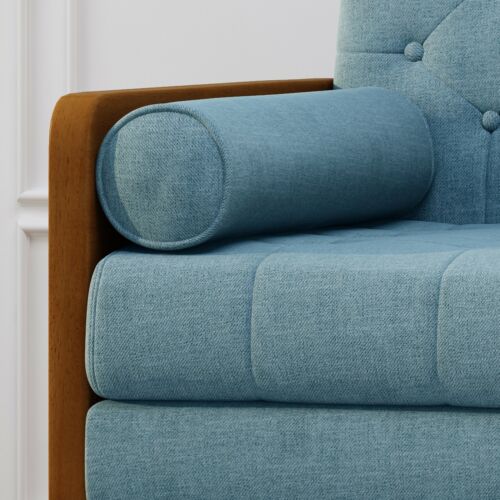 Close-up of blue fabric club chair with wooden armrest and cylindrical pillow.