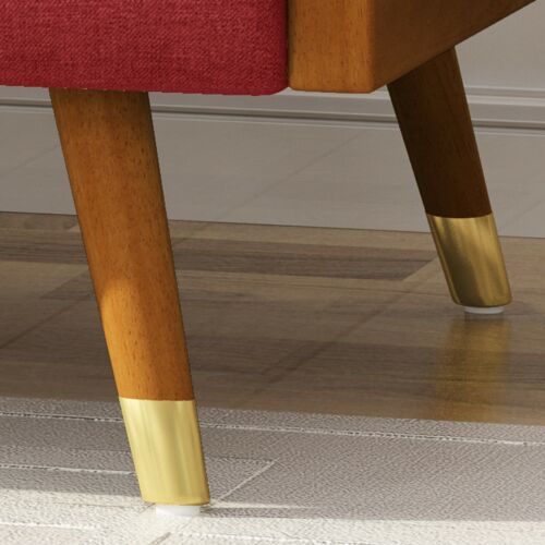 Close-up of a midcentury modern fabric chair leg with gold accent.