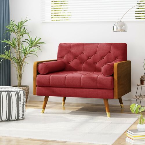 Modern red fabric club chair with wooden legs in a bright living room.
